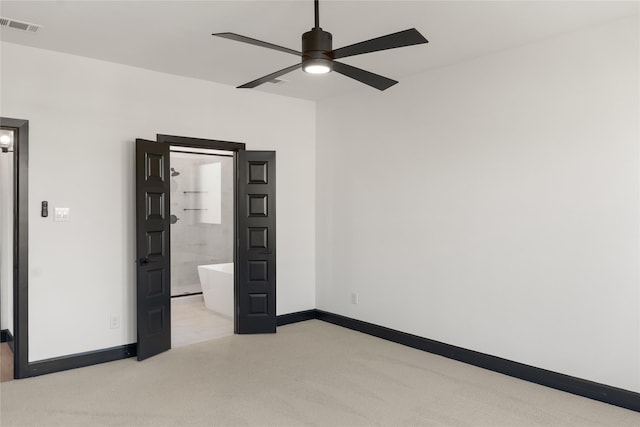 unfurnished bedroom with ceiling fan and connected bathroom