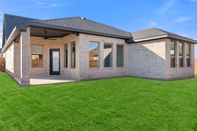 back of house featuring a lawn, ceiling fan, and a patio