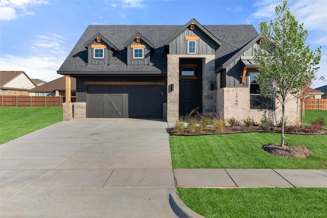 view of front of property featuring a garage and a front lawn