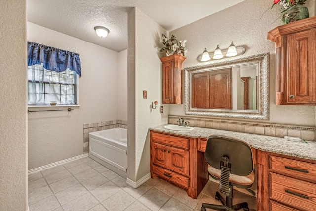 bathroom with tile patterned floors, a textured wall, a textured ceiling, and a bath