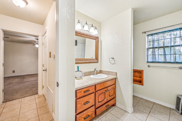 bathroom featuring tile patterned flooring, vanity, and ceiling fan