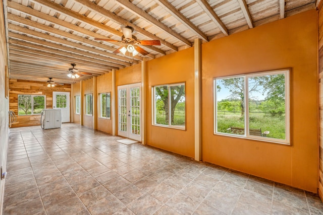 unfurnished sunroom with wooden ceiling, beam ceiling, and a ceiling fan