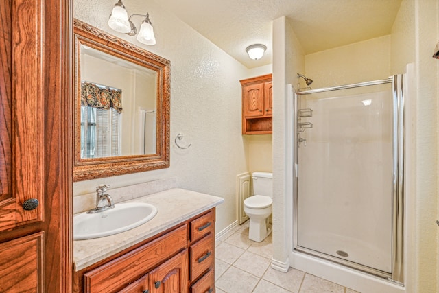 bathroom with a textured ceiling, tile patterned flooring, toilet, vanity, and a shower stall