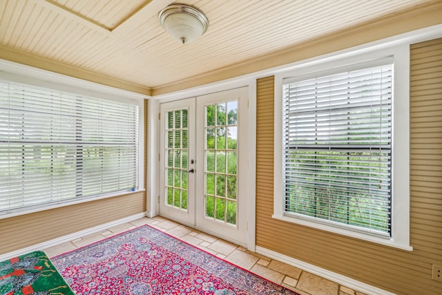 unfurnished sunroom with french doors