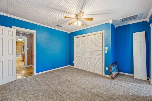 unfurnished bedroom with carpet floors, ceiling fan, ornamental molding, and a closet