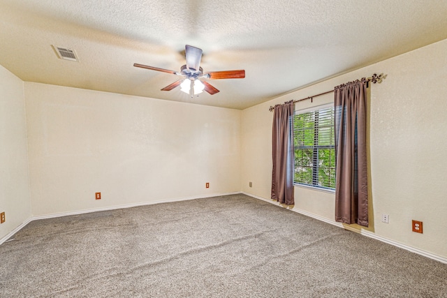 carpeted empty room featuring a textured ceiling and ceiling fan