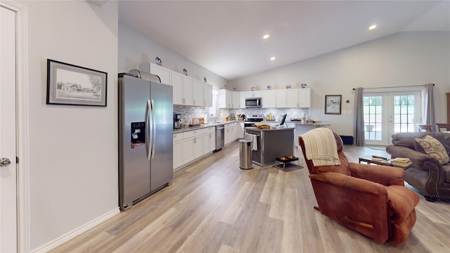 kitchen with white cabinets, a kitchen island, light hardwood / wood-style floors, and appliances with stainless steel finishes