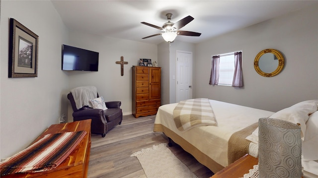 bedroom with ceiling fan and light wood-type flooring