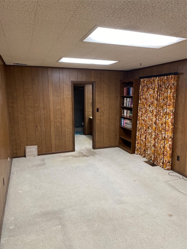 basement with wooden walls and carpet flooring