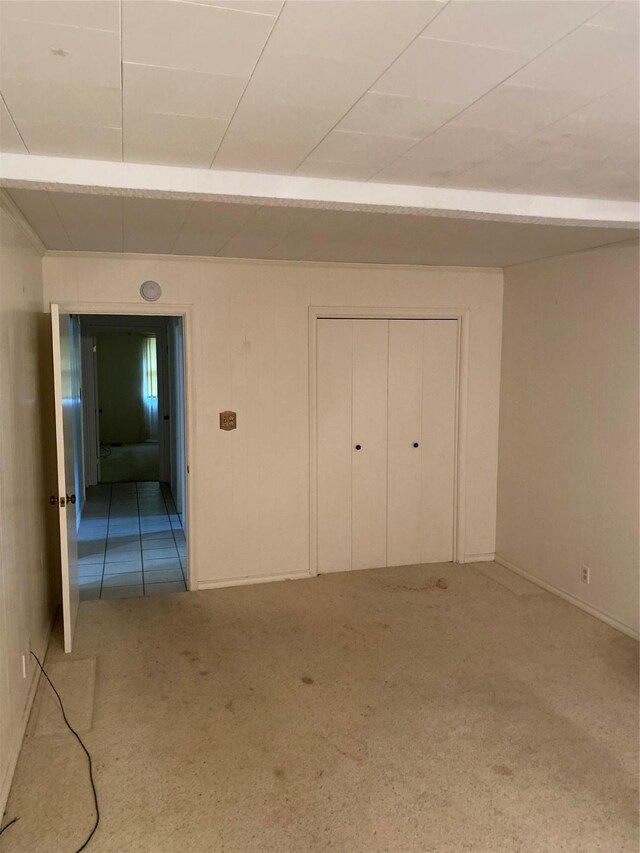 unfurnished bedroom featuring carpet flooring and a closet