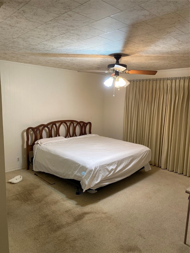 bedroom with ceiling fan and carpet floors