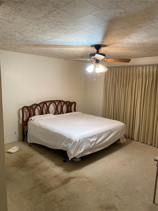bedroom with a ceiling fan and carpet flooring