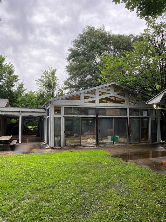 rear view of property featuring a yard