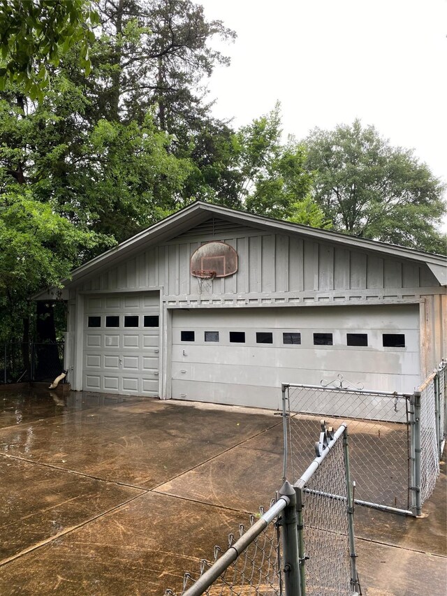 garage with fence and a gate