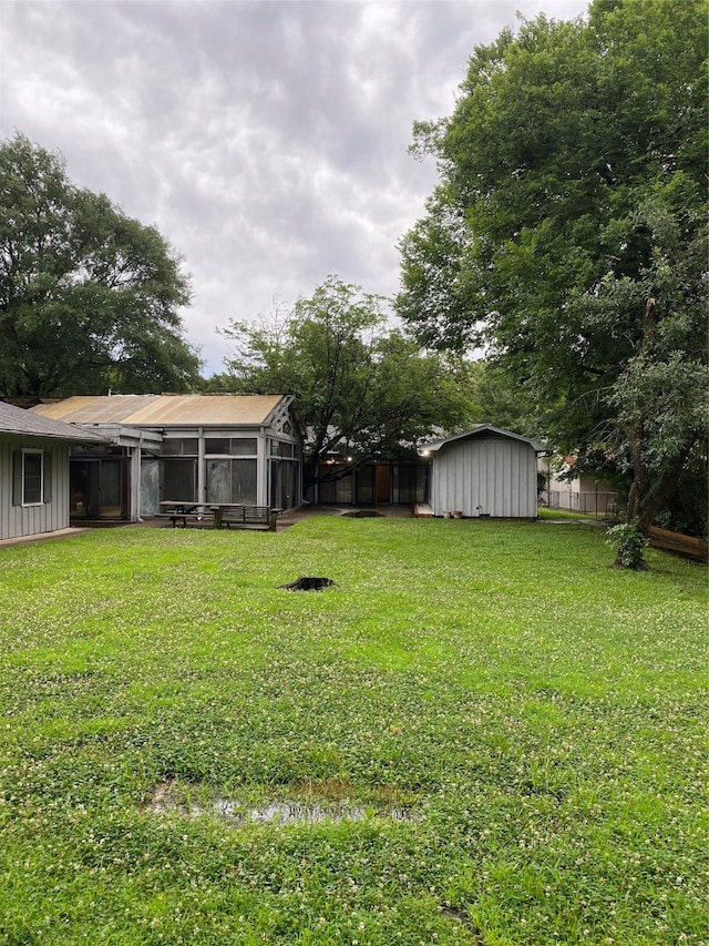 view of yard with a storage unit and a sunroom