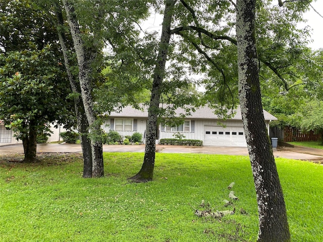 ranch-style home with a front lawn and a garage