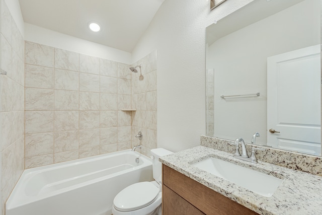 full bathroom featuring lofted ceiling, tiled shower / bath combo, vanity, and toilet