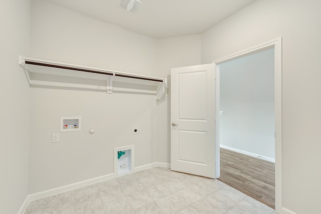 clothes washing area with washer hookup, gas dryer hookup, light hardwood / wood-style flooring, and electric dryer hookup