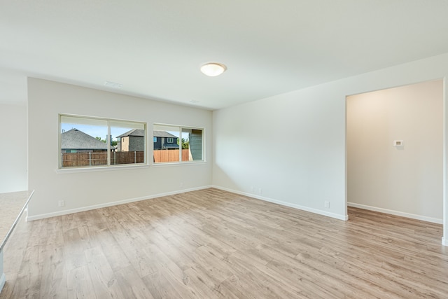 empty room with light hardwood / wood-style floors