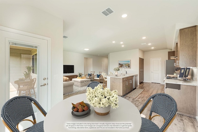 dining area featuring light hardwood / wood-style floors and sink