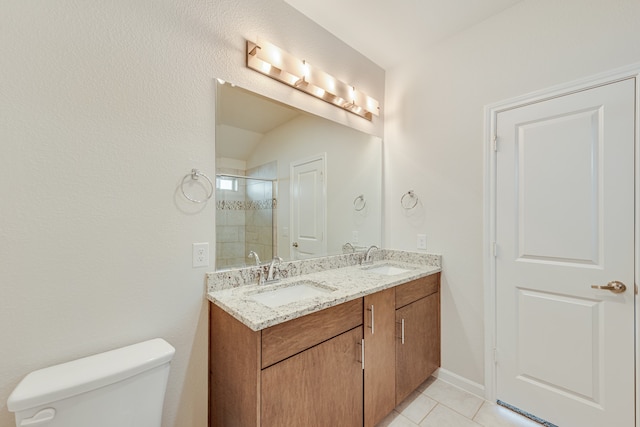 bathroom with vanity, tile patterned flooring, toilet, and an enclosed shower