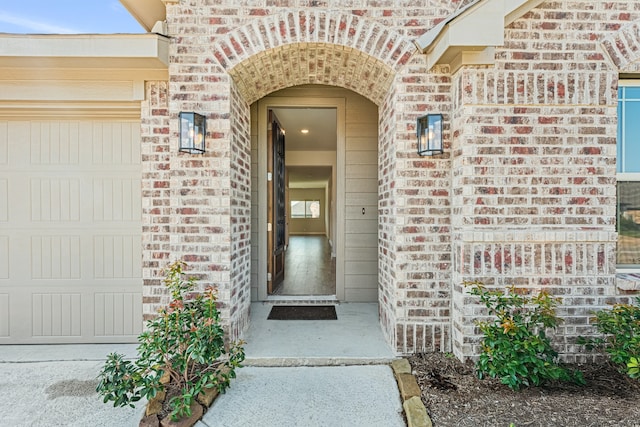 doorway to property with a garage