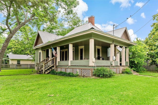 view of front of home with covered porch and a front lawn