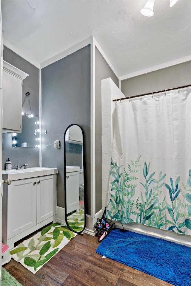 bathroom featuring vanity, hardwood / wood-style flooring, and curtained shower