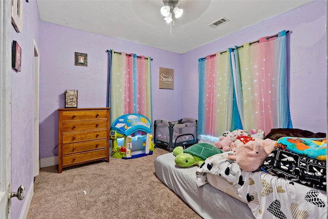 bedroom with ceiling fan and light carpet