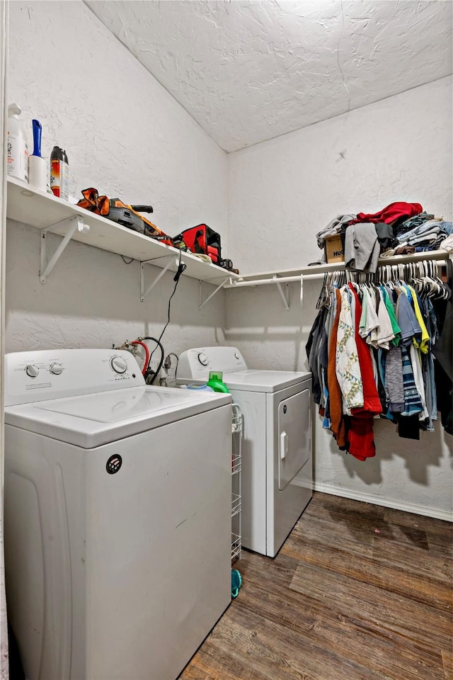 laundry room with washer and dryer, dark hardwood / wood-style floors, and a textured ceiling