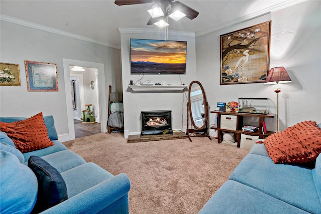 living room featuring ceiling fan, ornamental molding, and carpet floors