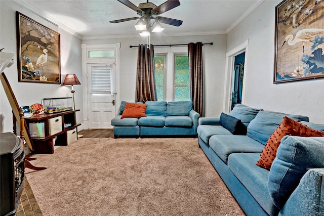 living room featuring crown molding, carpet floors, ceiling fan, and a textured ceiling