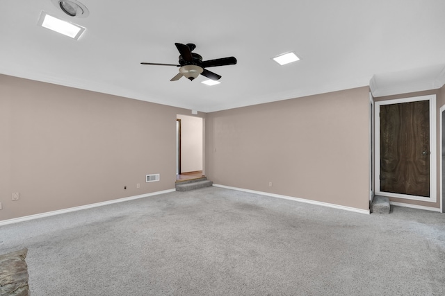 carpeted spare room featuring ceiling fan and ornamental molding