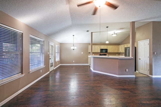 unfurnished living room featuring ceiling fan with notable chandelier, a textured ceiling, dark hardwood / wood-style flooring, and vaulted ceiling