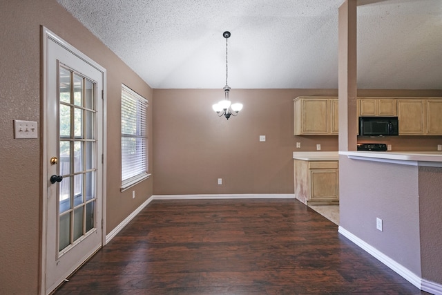 kitchen featuring light brown cabinetry, dark hardwood / wood-style flooring, hanging light fixtures, and lofted ceiling