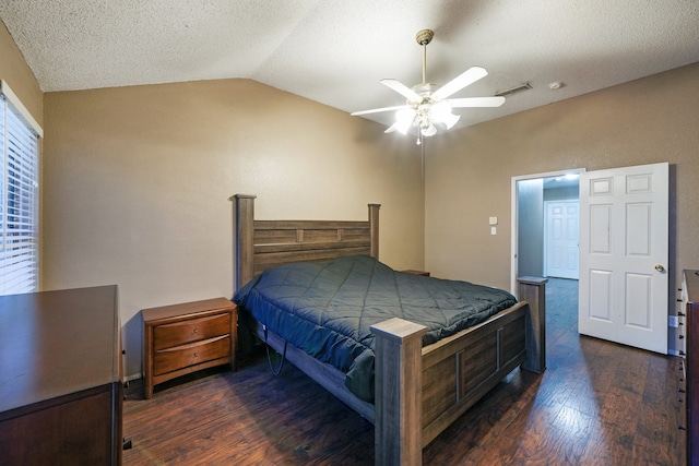 bedroom featuring a textured ceiling, dark hardwood / wood-style floors, vaulted ceiling, and ceiling fan