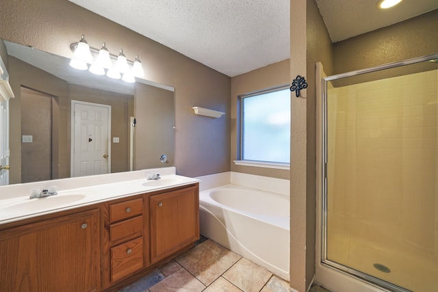 bathroom featuring tile patterned floors, vanity, separate shower and tub, and a textured ceiling