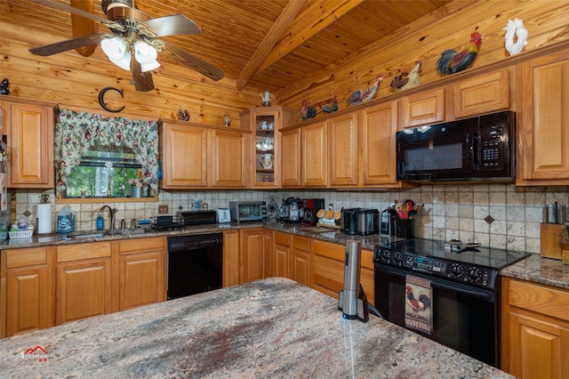 kitchen featuring sink, black appliances, beam ceiling, and dark stone counters