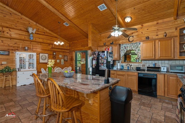 kitchen with sink, black appliances, a kitchen breakfast bar, and stone countertops