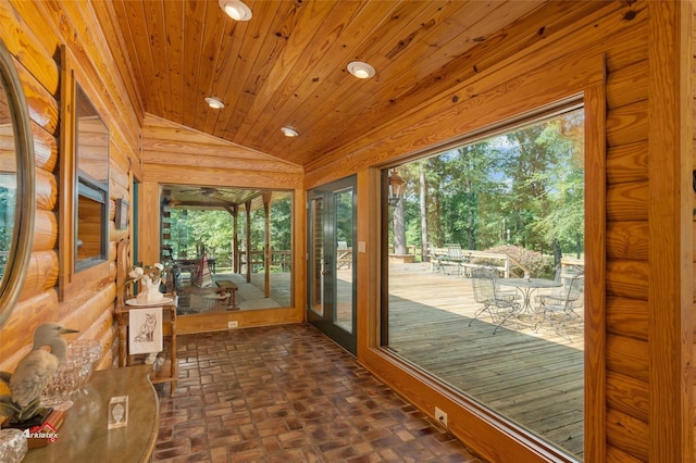 doorway to outside with wood ceiling and vaulted ceiling