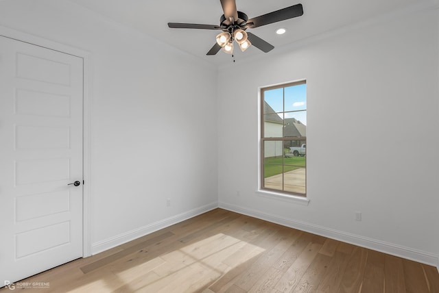 spare room featuring ceiling fan, a wealth of natural light, and light hardwood / wood-style floors