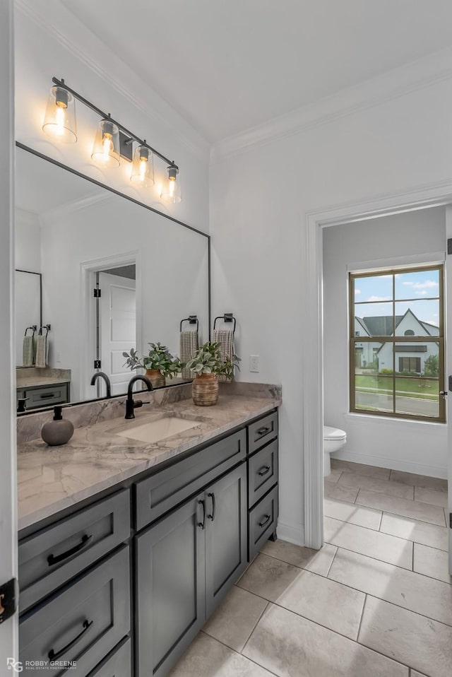 bathroom with toilet, crown molding, tile patterned floors, and vanity