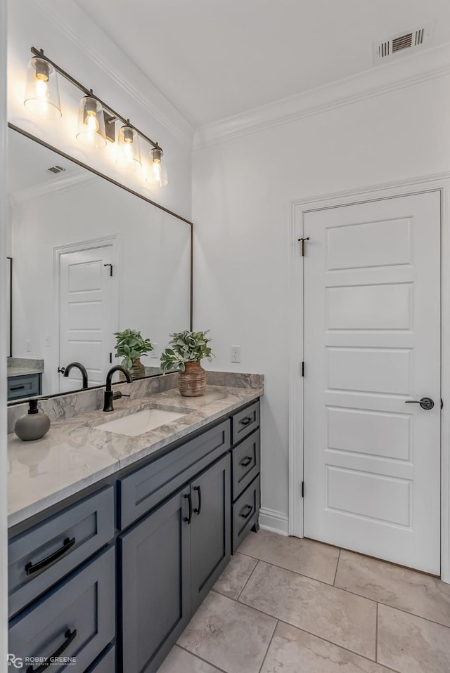 bathroom featuring vanity, crown molding, and tile patterned flooring