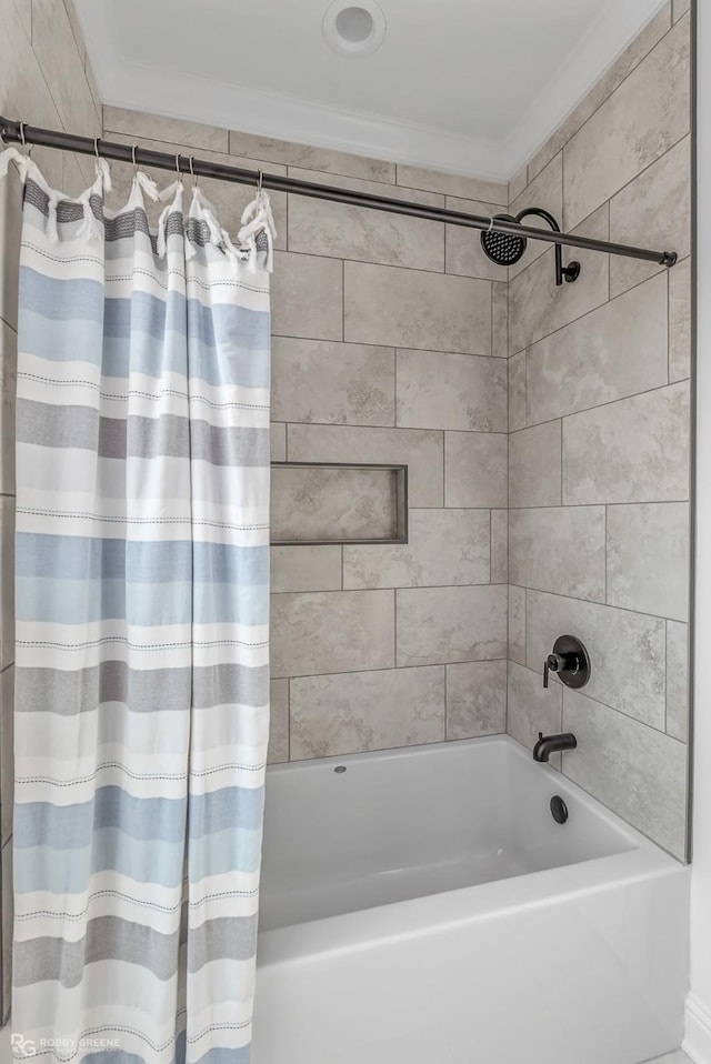 bathroom featuring ornamental molding and shower / bathtub combination with curtain