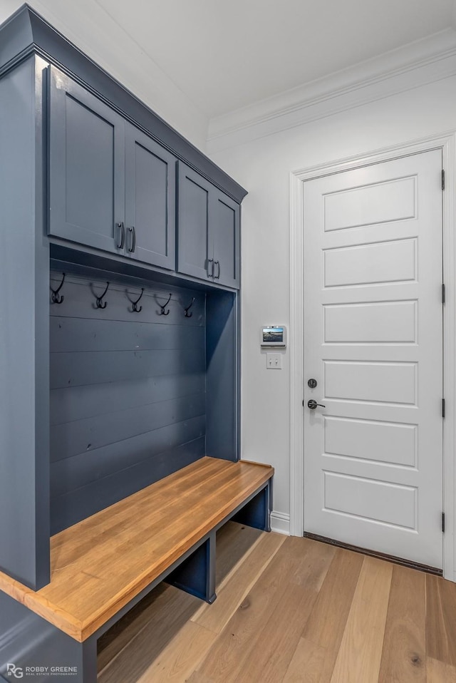 mudroom with hardwood / wood-style floors and ornamental molding