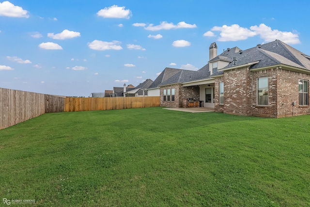 back of property featuring a yard and a patio