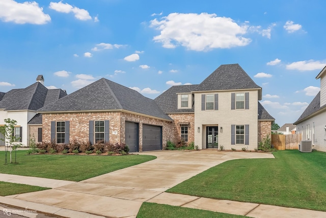 view of front of house featuring a garage, a front yard, and central AC