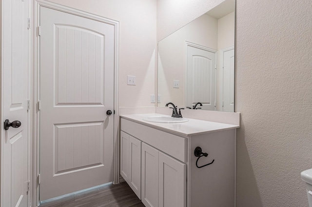 bathroom with hardwood / wood-style flooring and vanity