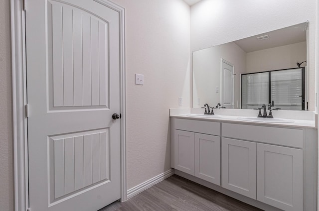 bathroom with vanity and wood-type flooring