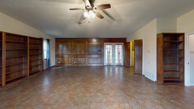 203 Mesa Dr, Gatesville, TX 76528 - empty room featuring visible vents, lofted ceiling, french doors, a textured ceiling, and a ceiling fan